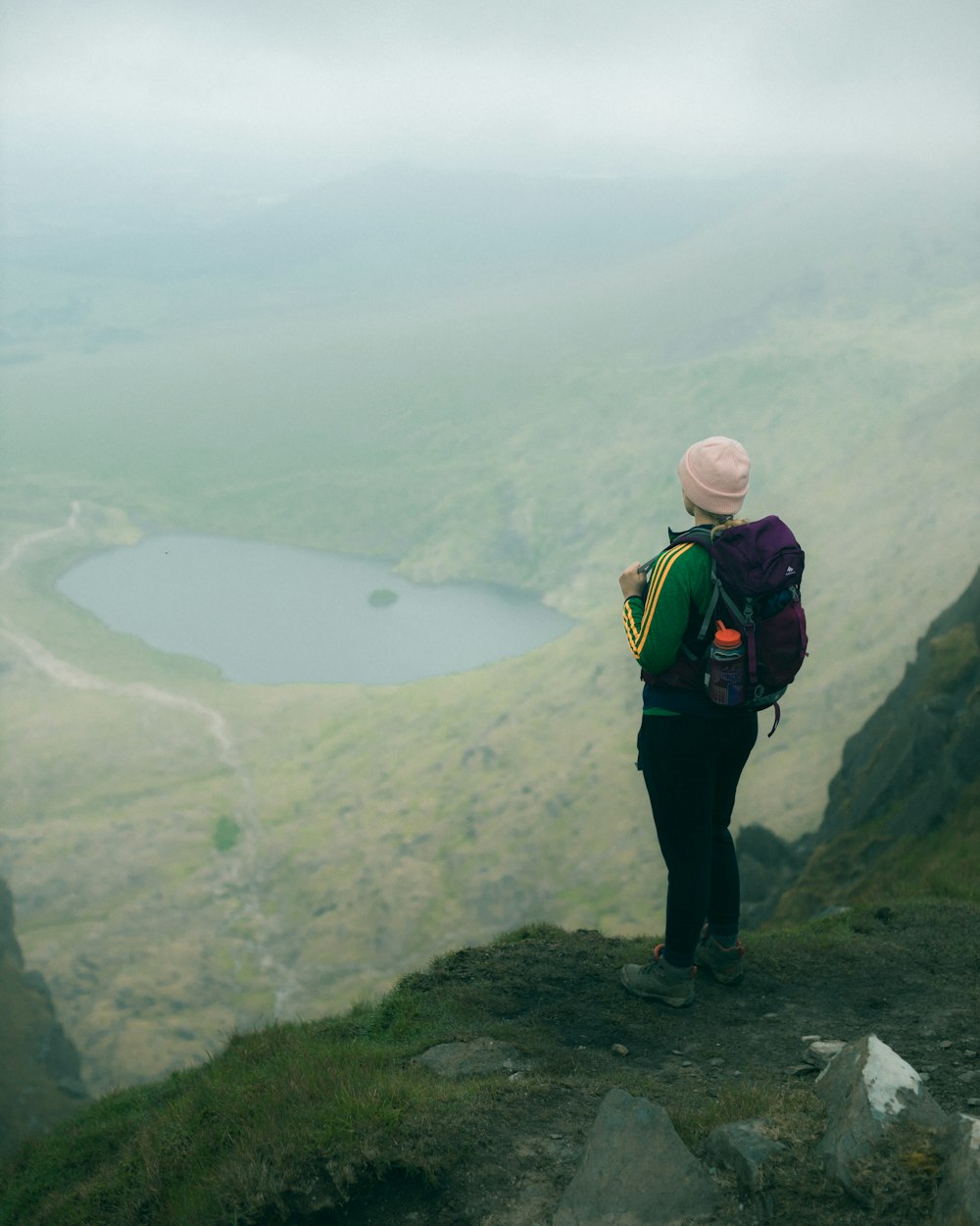 man in black pants standing on top of mountain during daytime