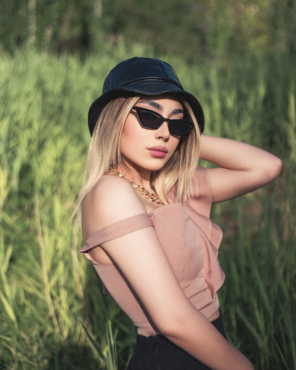 woman in black sunglasses and brown sleeveless dress