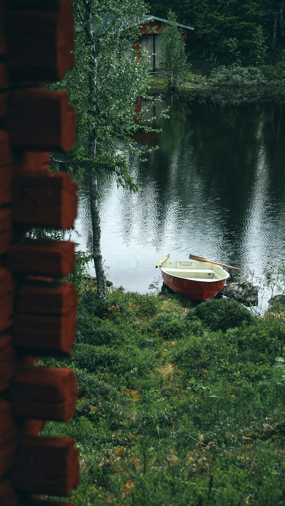 white and red boat on lake