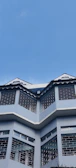 Completed commercial building featuring royal blue and white exterior design.