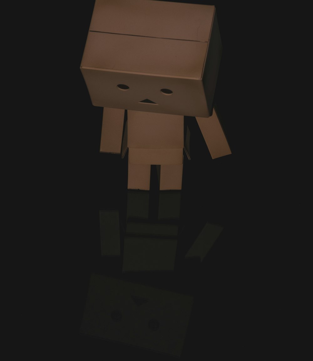 brown cardboard robot on white background