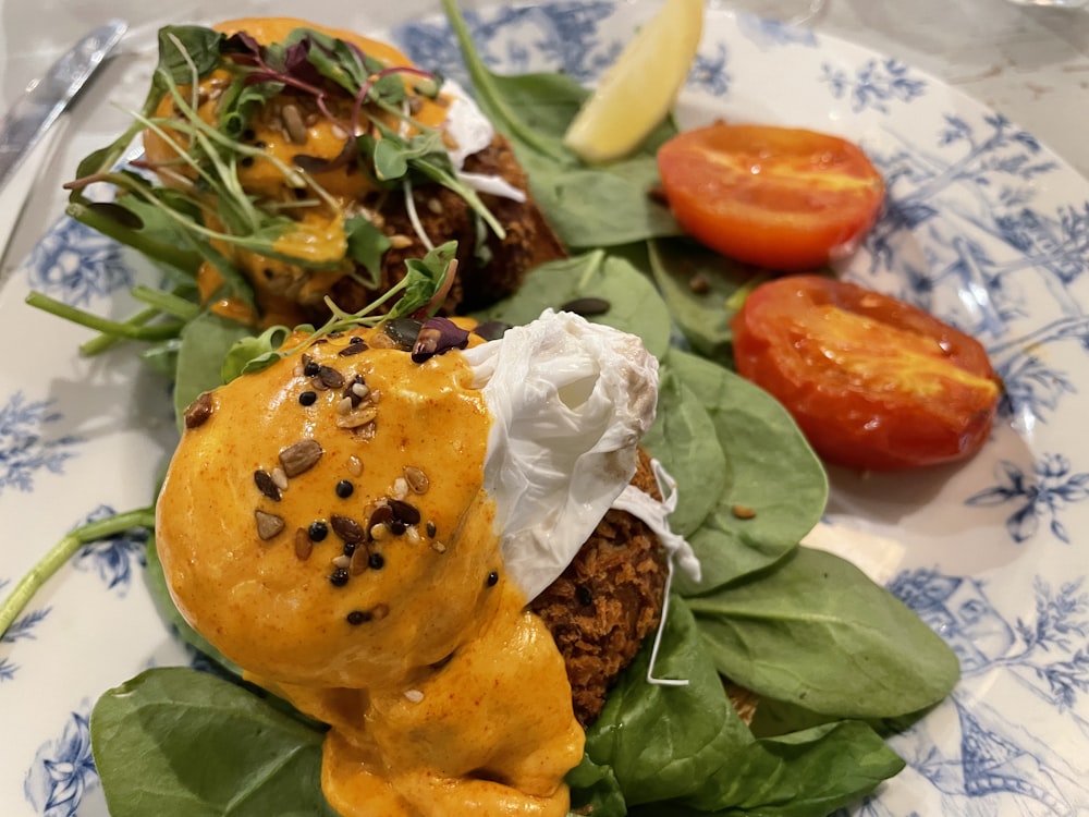 egg with green leaves and red tomato on white ceramic plate