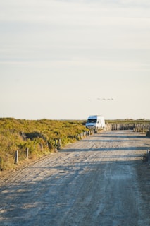 A White Stork Transport sprinter cargovan on the road.