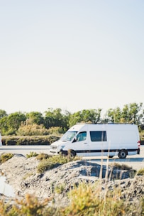 white van on gray concrete road during daytime