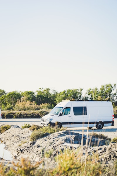 white van on gray concrete road during daytime