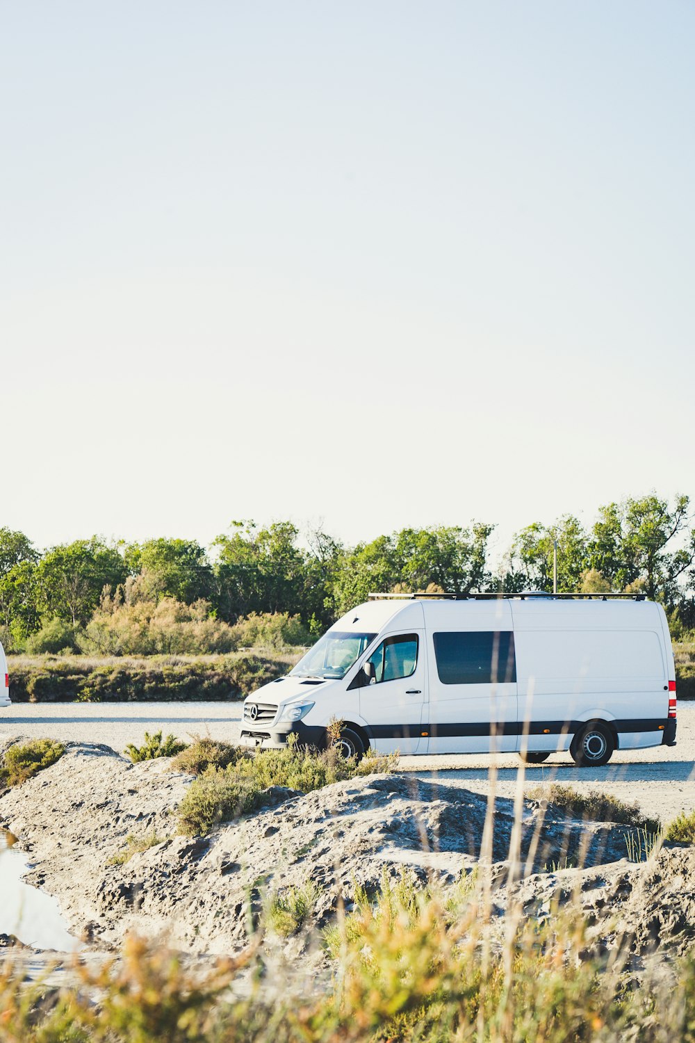 white van on gray concrete road during daytime