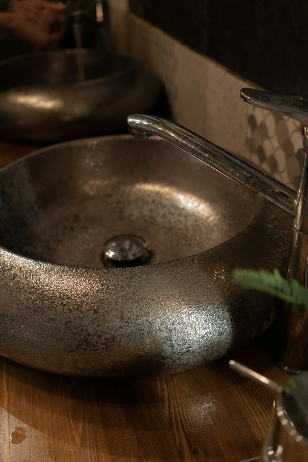 stainless steel faucet on brown ceramic sink