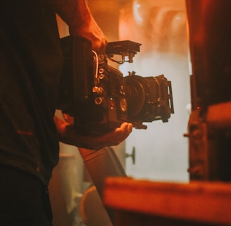 person holding black dslr camera