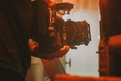 person holding black dslr camera