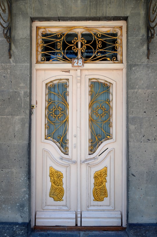white wooden door with brass door lever in Gyumri Armenia