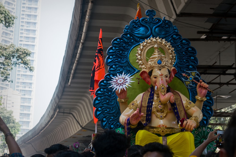 gold hindu deity statue near white wall