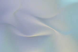 Soft gradient background with subtle abstract vascular flow lines and faint geometric curves in calming blue-gray tones.