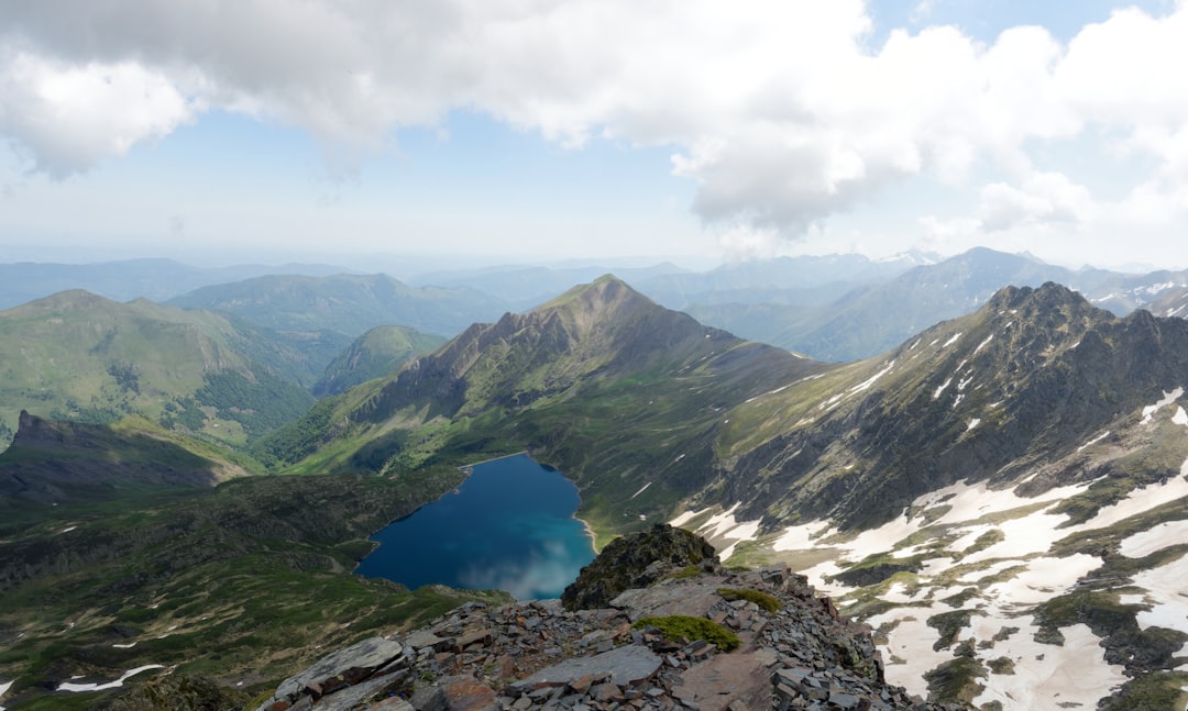 green and gray mountains under white clouds and blue sky during daytime