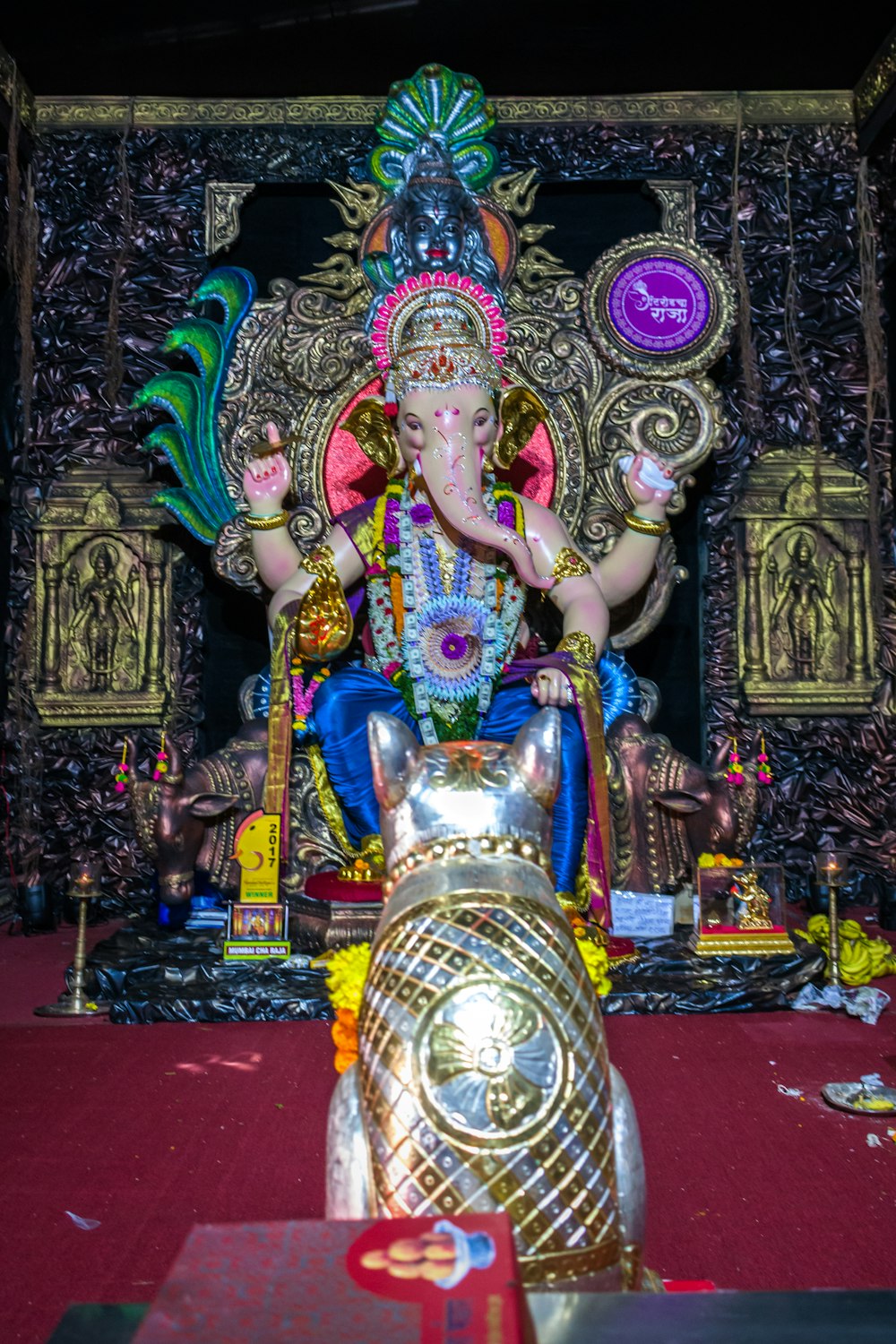 hindu deity statue on red textile