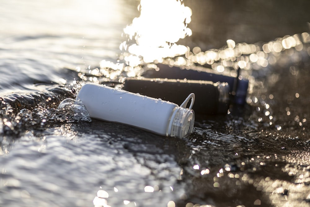 white disposable cup on water