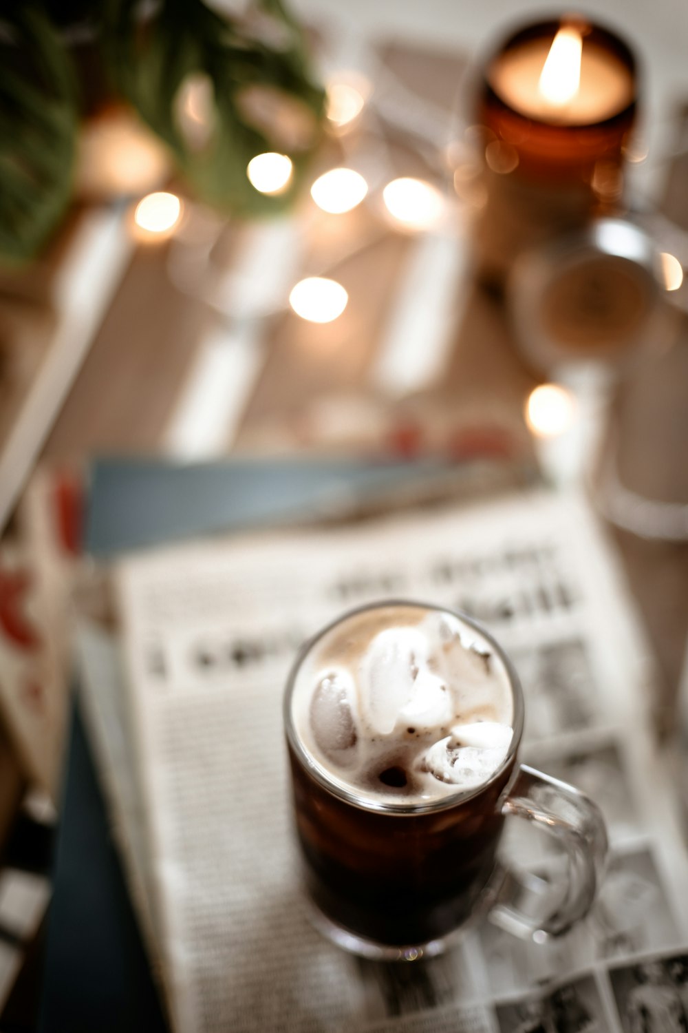 clear glass mug on newspaper