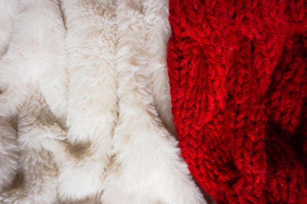 white fur textile on red textile