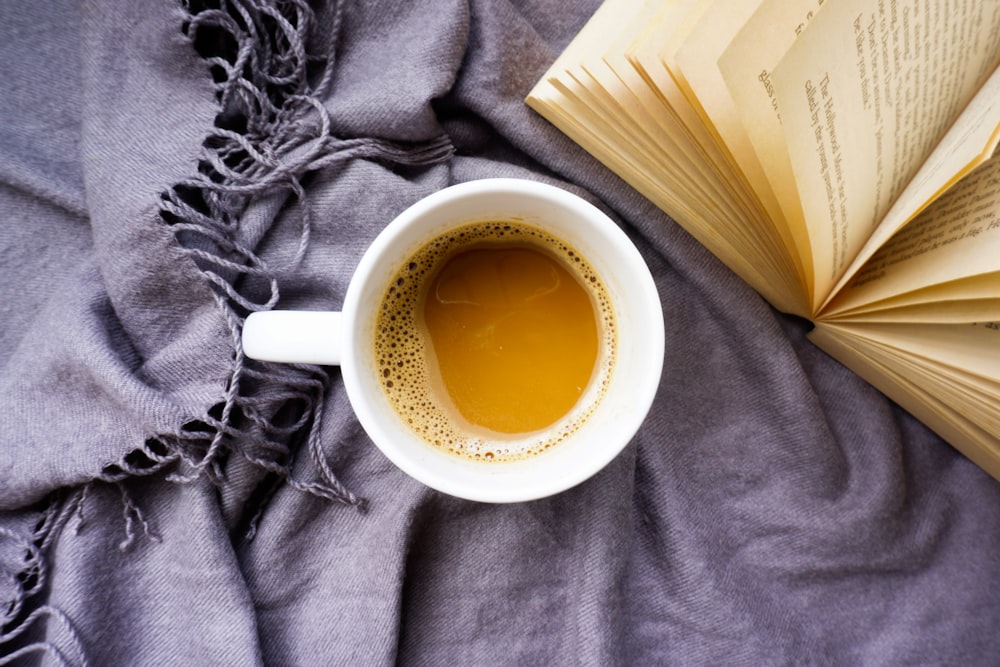 white ceramic mug with brown liquid inside