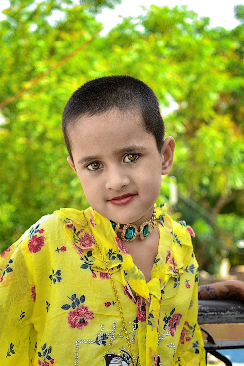 boy in yellow and blue floral button up shirt