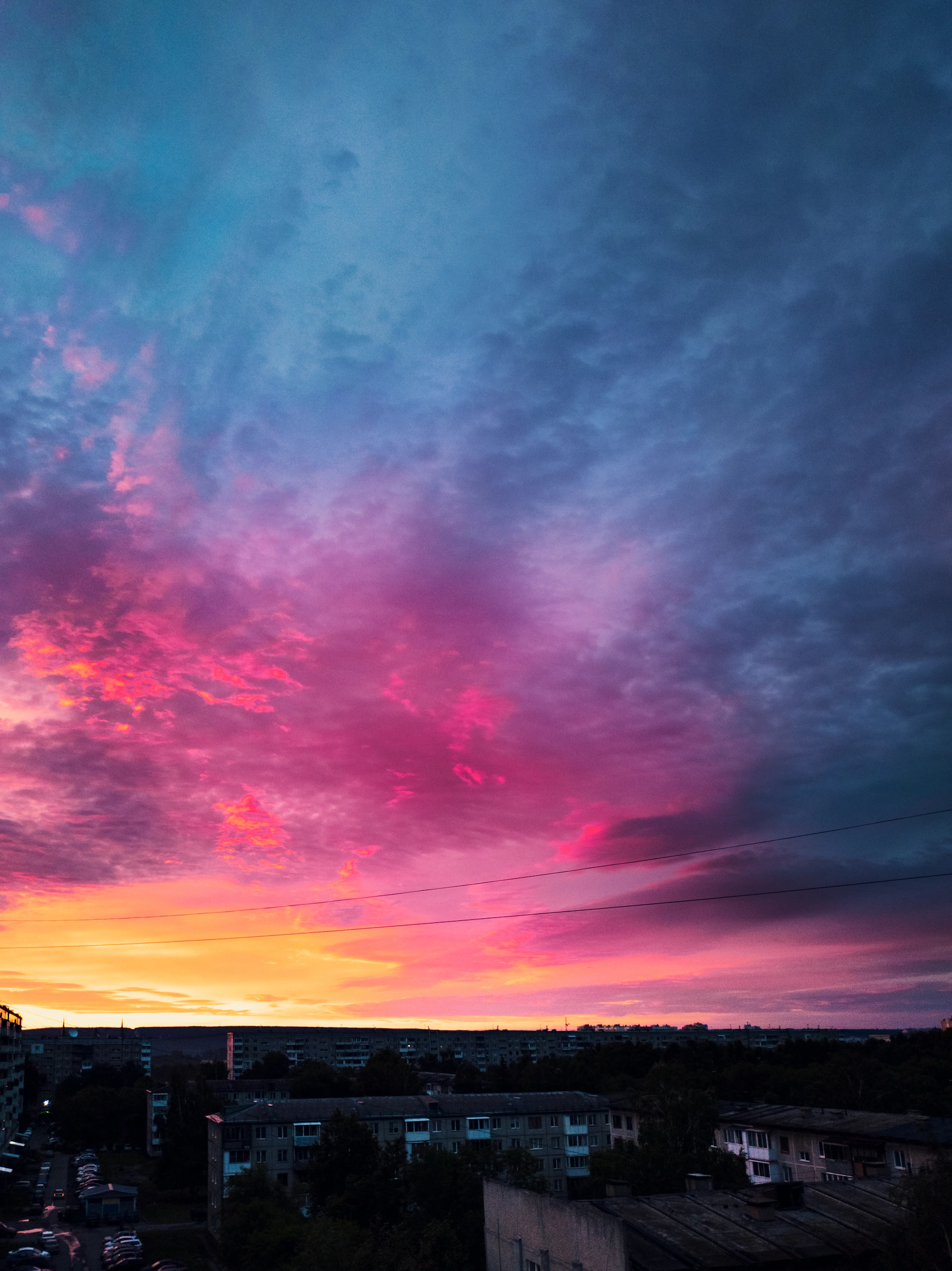 A vibrant carousel image showing a colorful cityscape at sunset, inviting visitors to explore more.