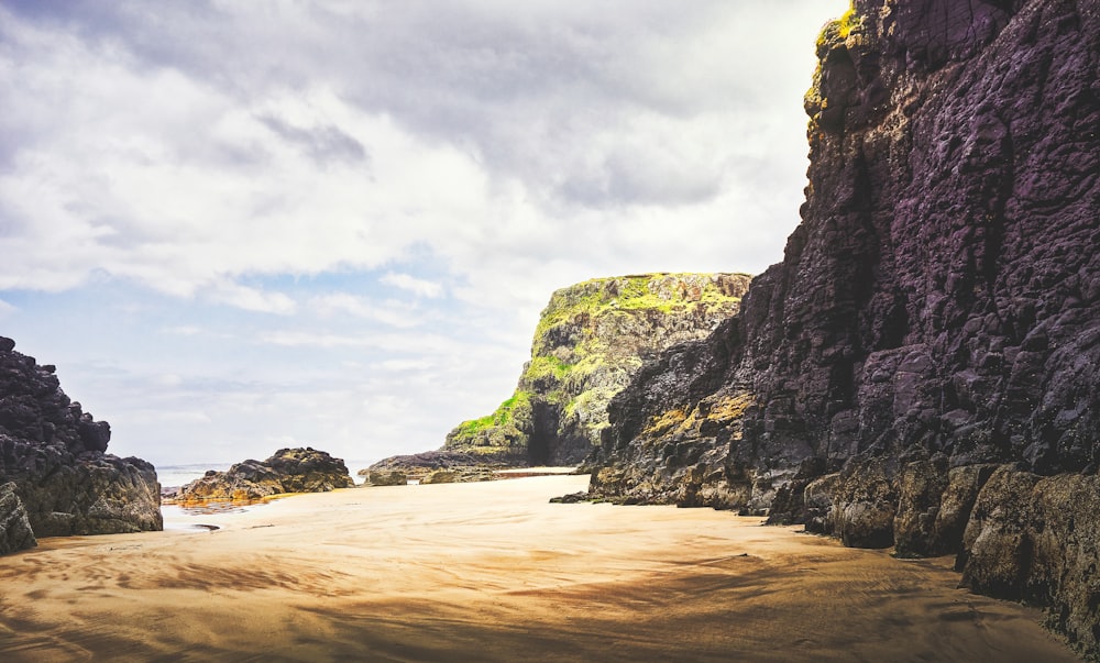 brown rock formation on sea shore during daytime