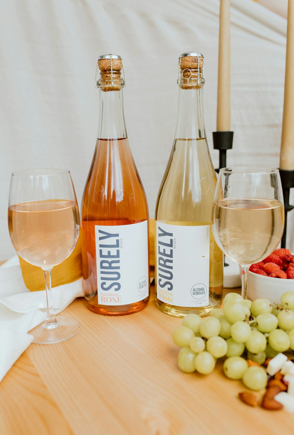 two clear glass bottles on brown wooden table