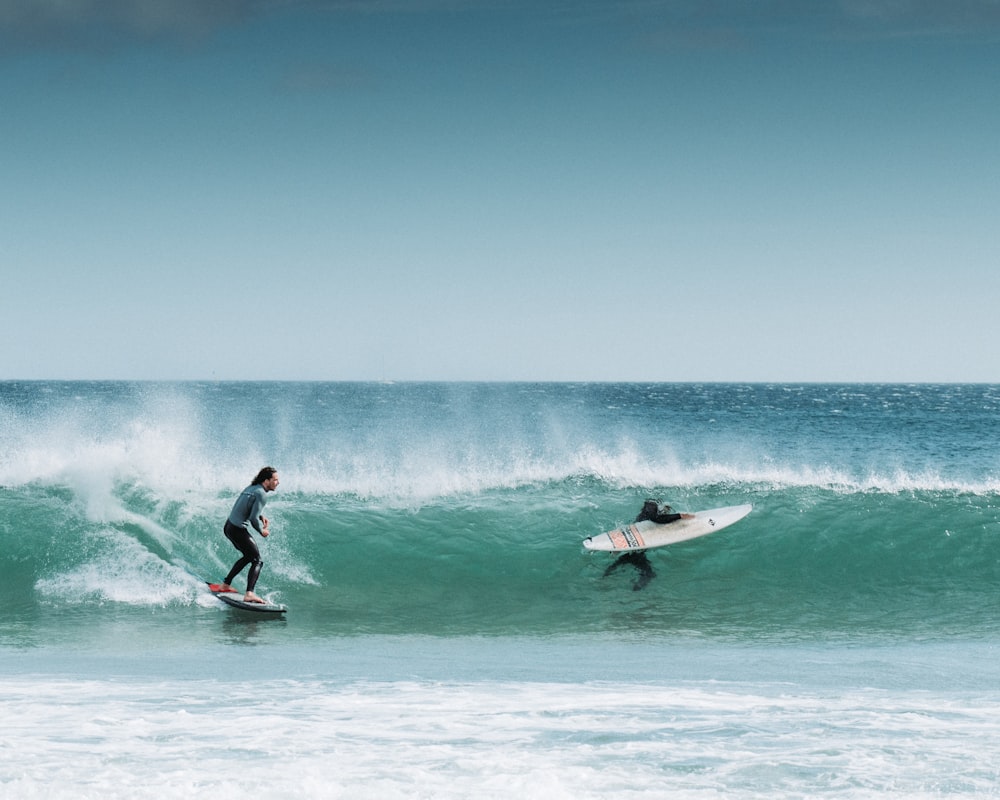 man surfing on sea waves during daytime