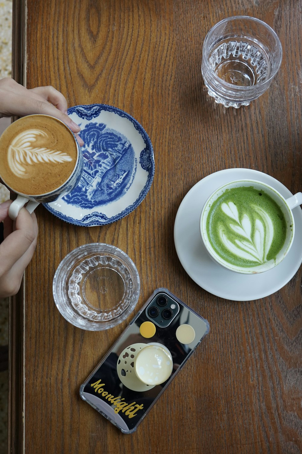 cappuccino in white ceramic mug on white ceramic saucer