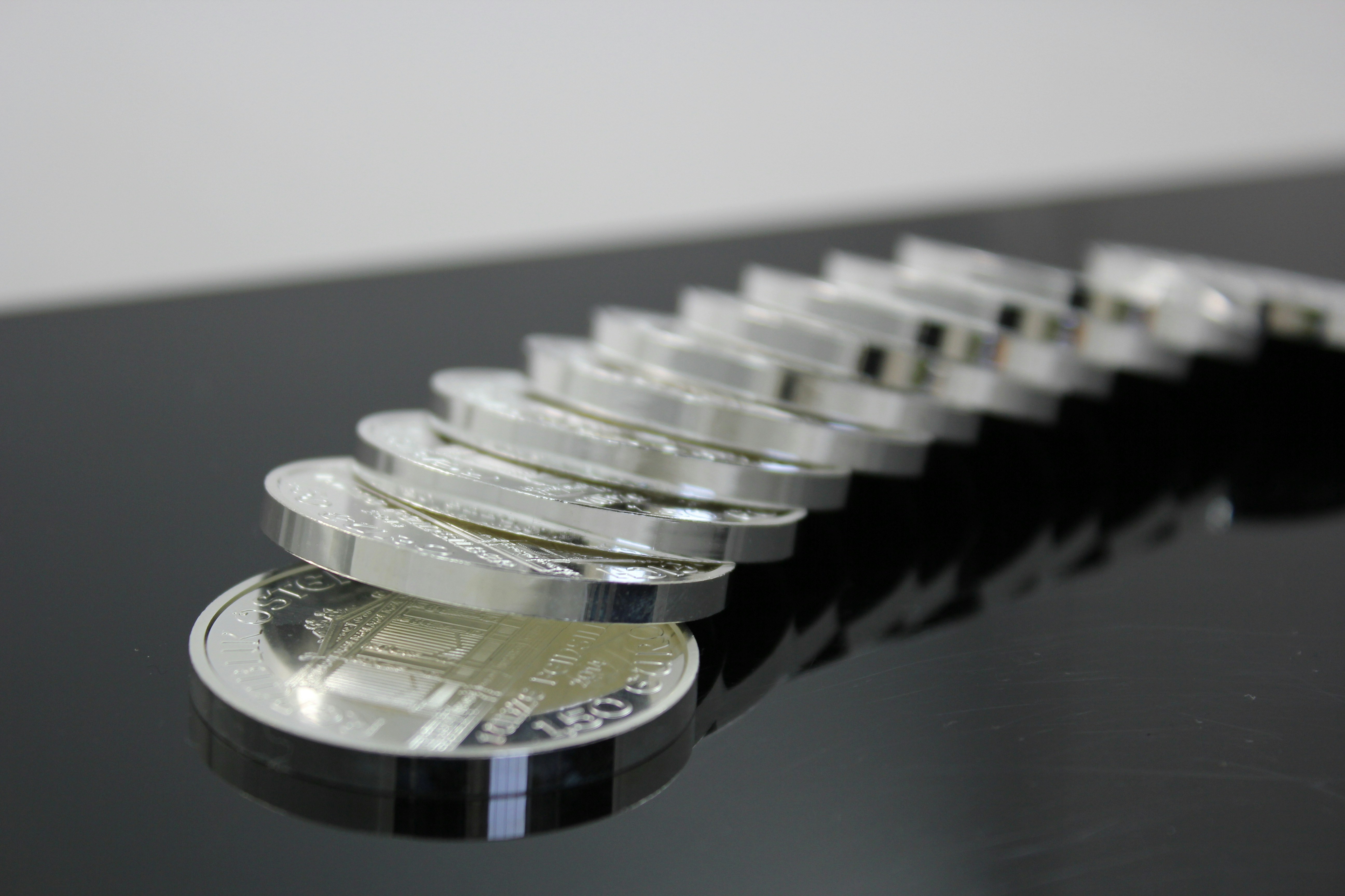 Pile of silver bullion coins Münze Österreich. If you use our photos, please add credit to https://zlataky.cz, when possible