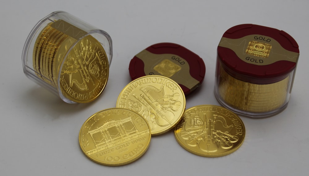 gold round coins on white surface