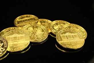 gold round coins on black surface