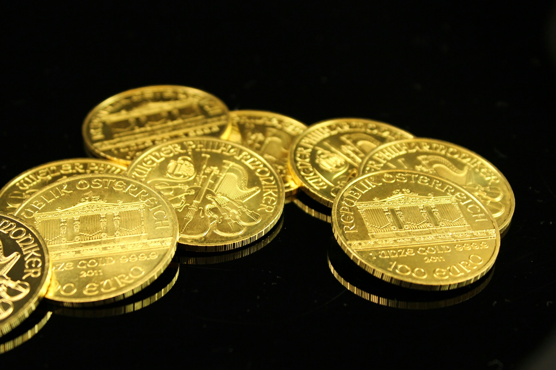gold round coins on black surface