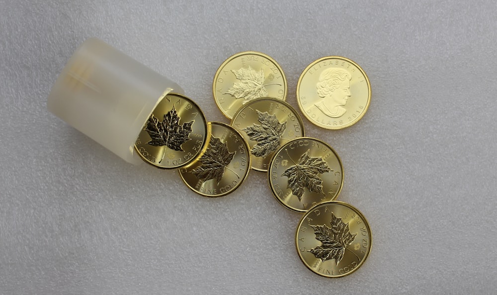 silver round coins on white surface