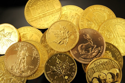 gold coins in pile on table representing gold ira pros and cons