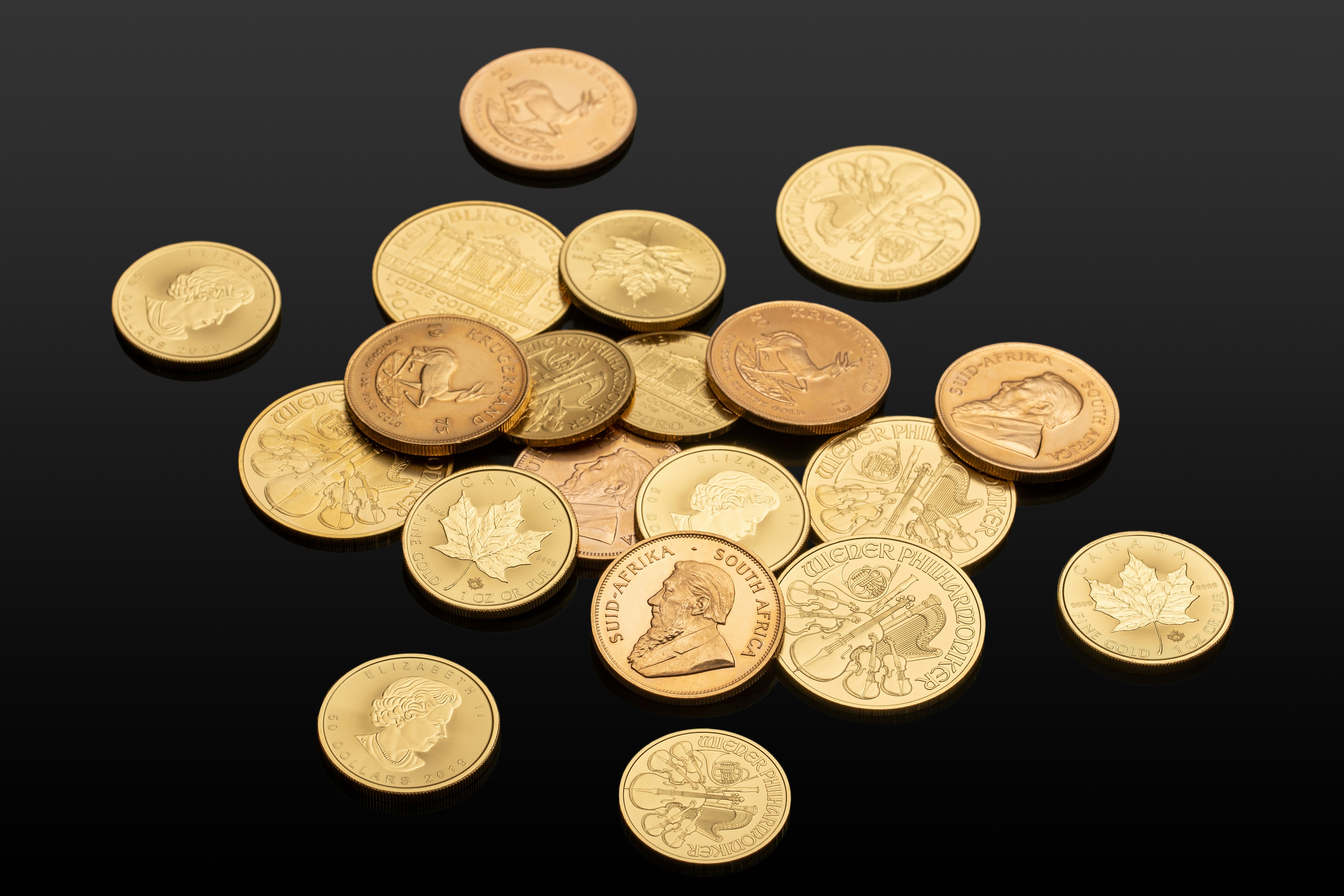 Pile of gold bullion coins. Münze Österreich, Royal Canadian Mint, U.S. Mint, Australian Mint of Perth and Krugerrand. If you use our photos, please add credit to https://zlataky.cz, when possible