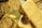 A collection of gold bars and coins, prominently displaying engravings such as '1 KILO Fine Gold 999.9' from Switzerland. The shiny surfaces reflect light, emphasizing the luxury and value associated with precious metals.