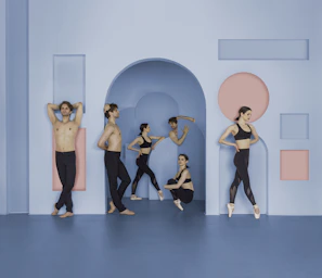 Group formation with synchronized poses against a minimalist backdrop