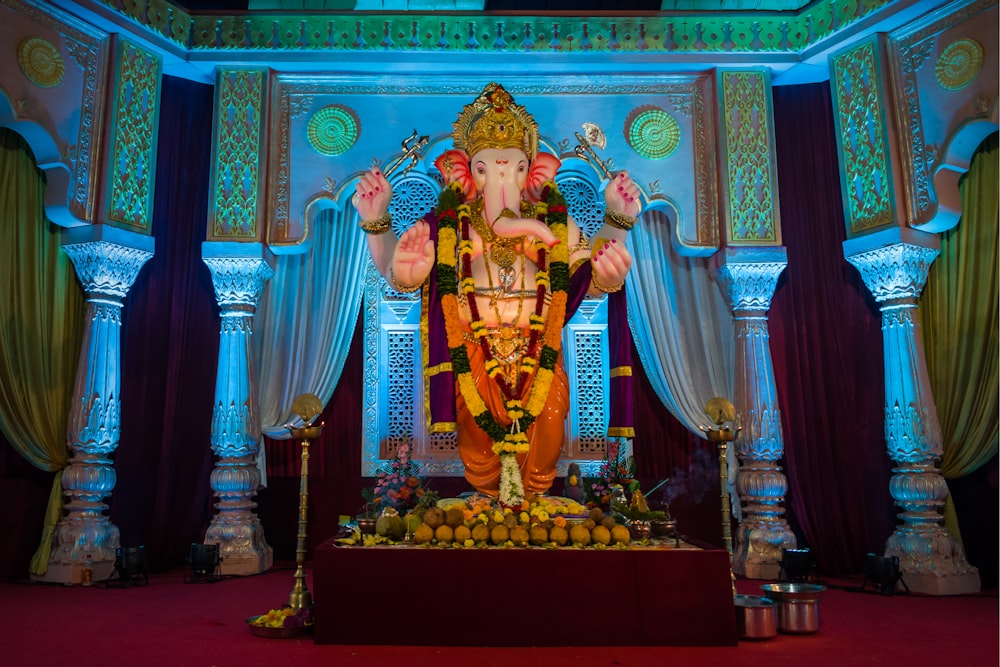 hindu deity statue on red and blue textile