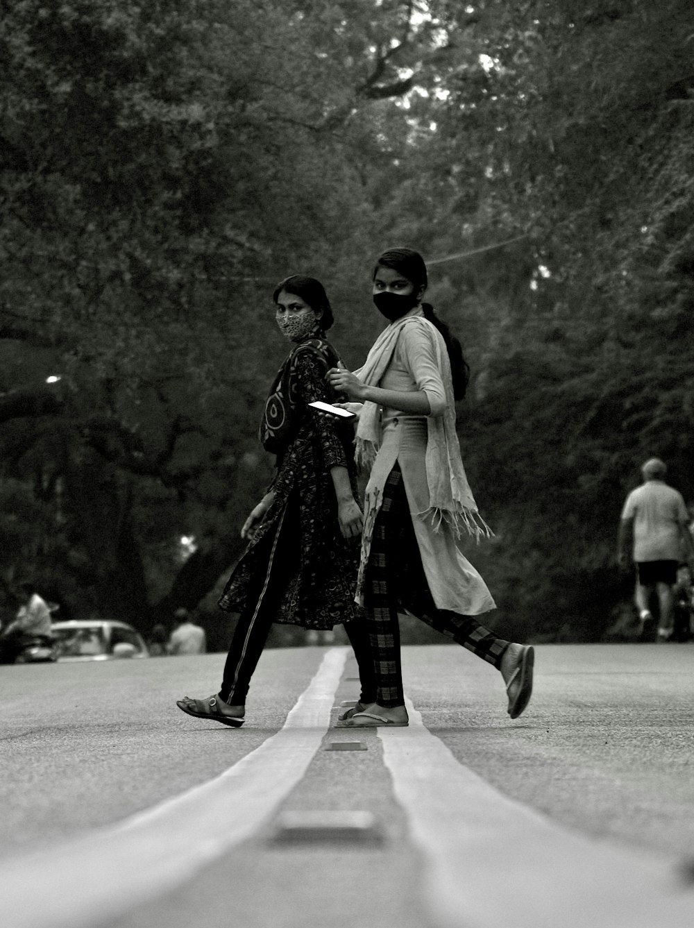 man in black coat walking on street