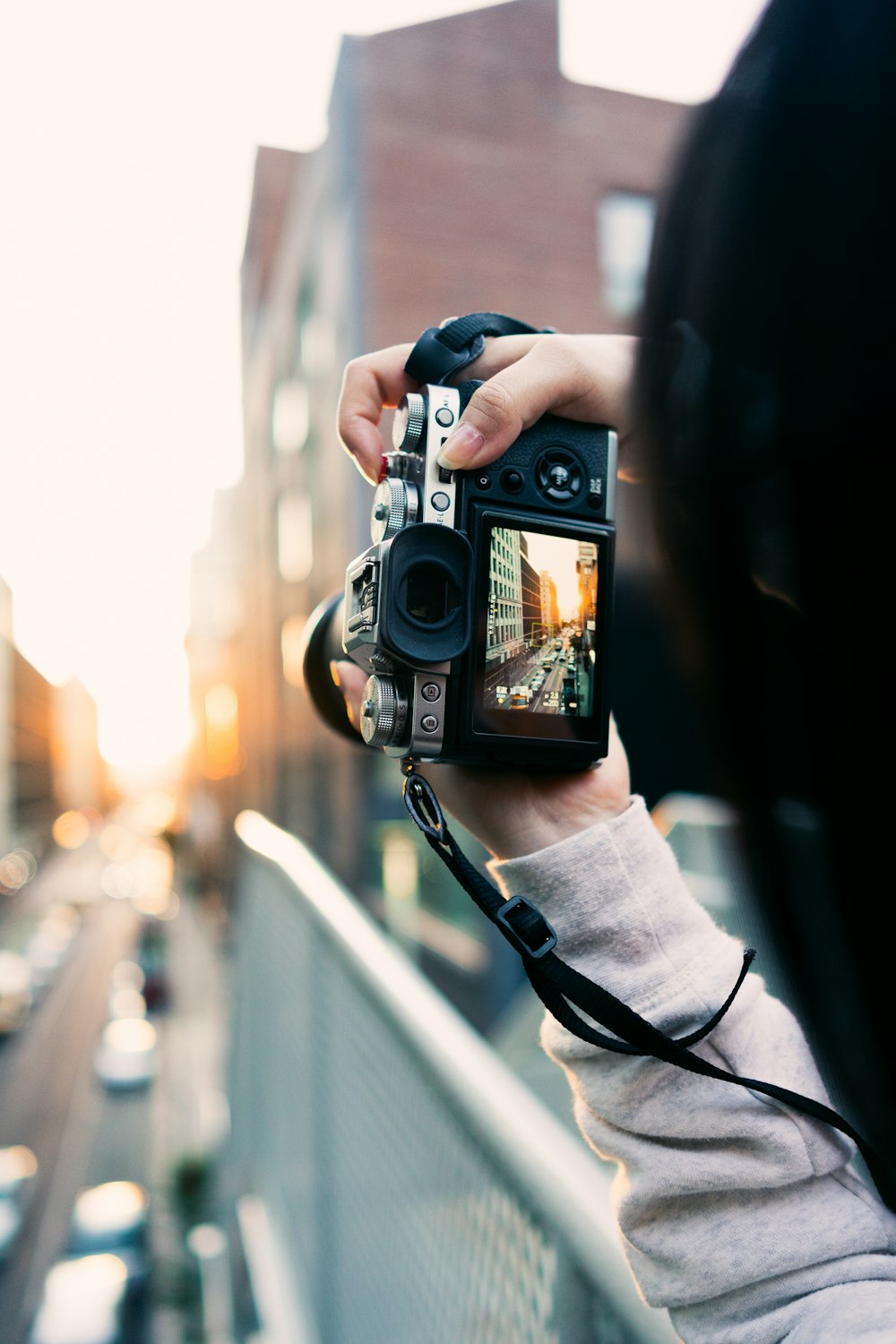 person holding black and silver camera