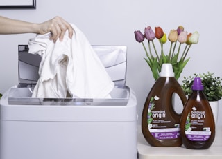 person holding brown plastic bottle