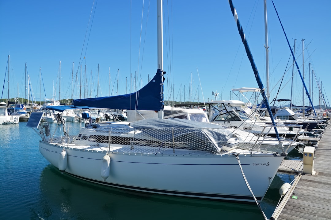 white sail boat on dock during daytime