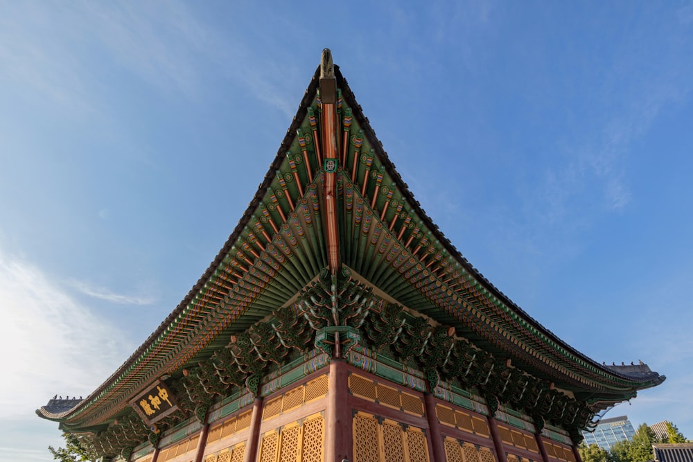 green and brown concrete building under blue sky during daytime