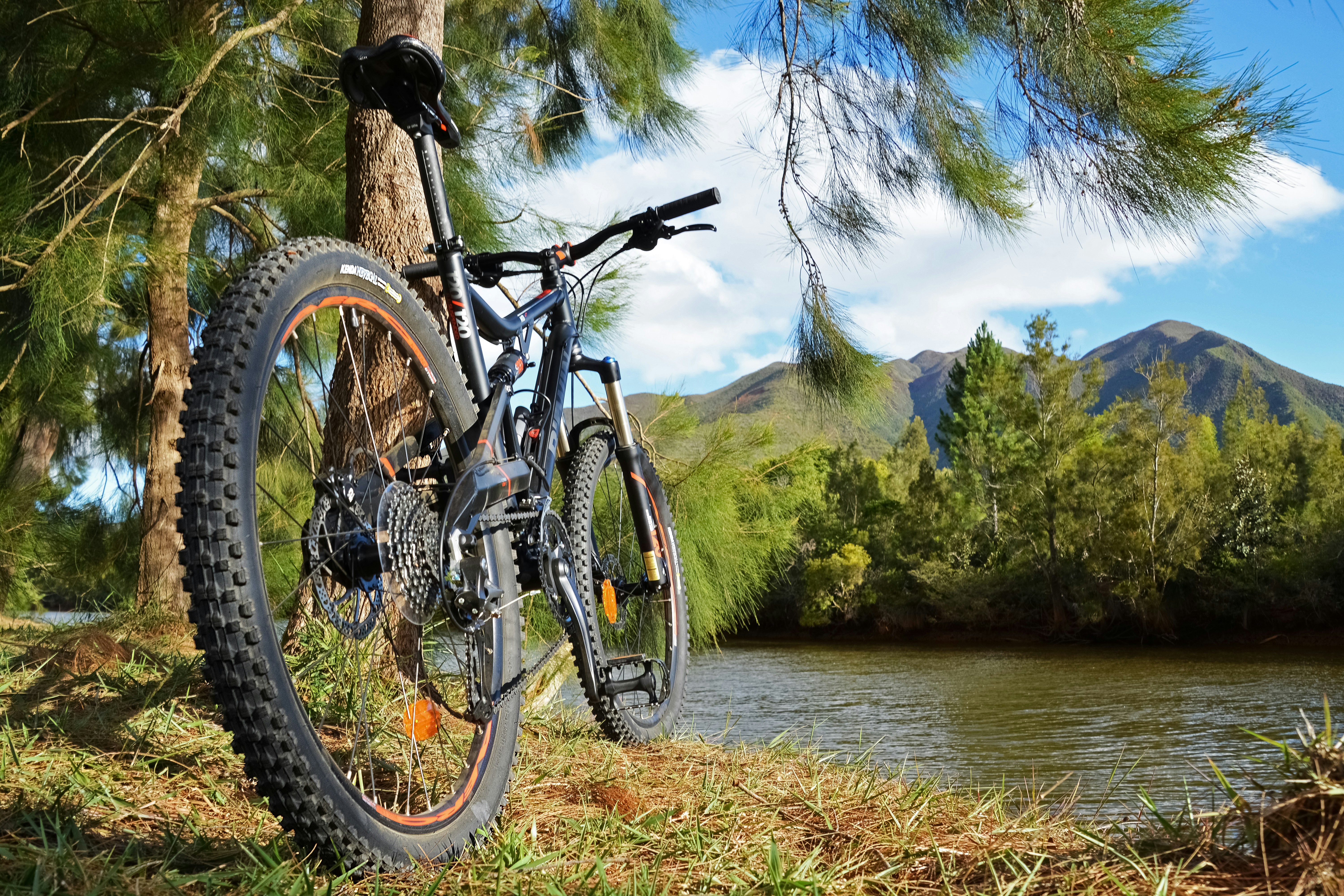 black and red mountain bike near body of water during daytime