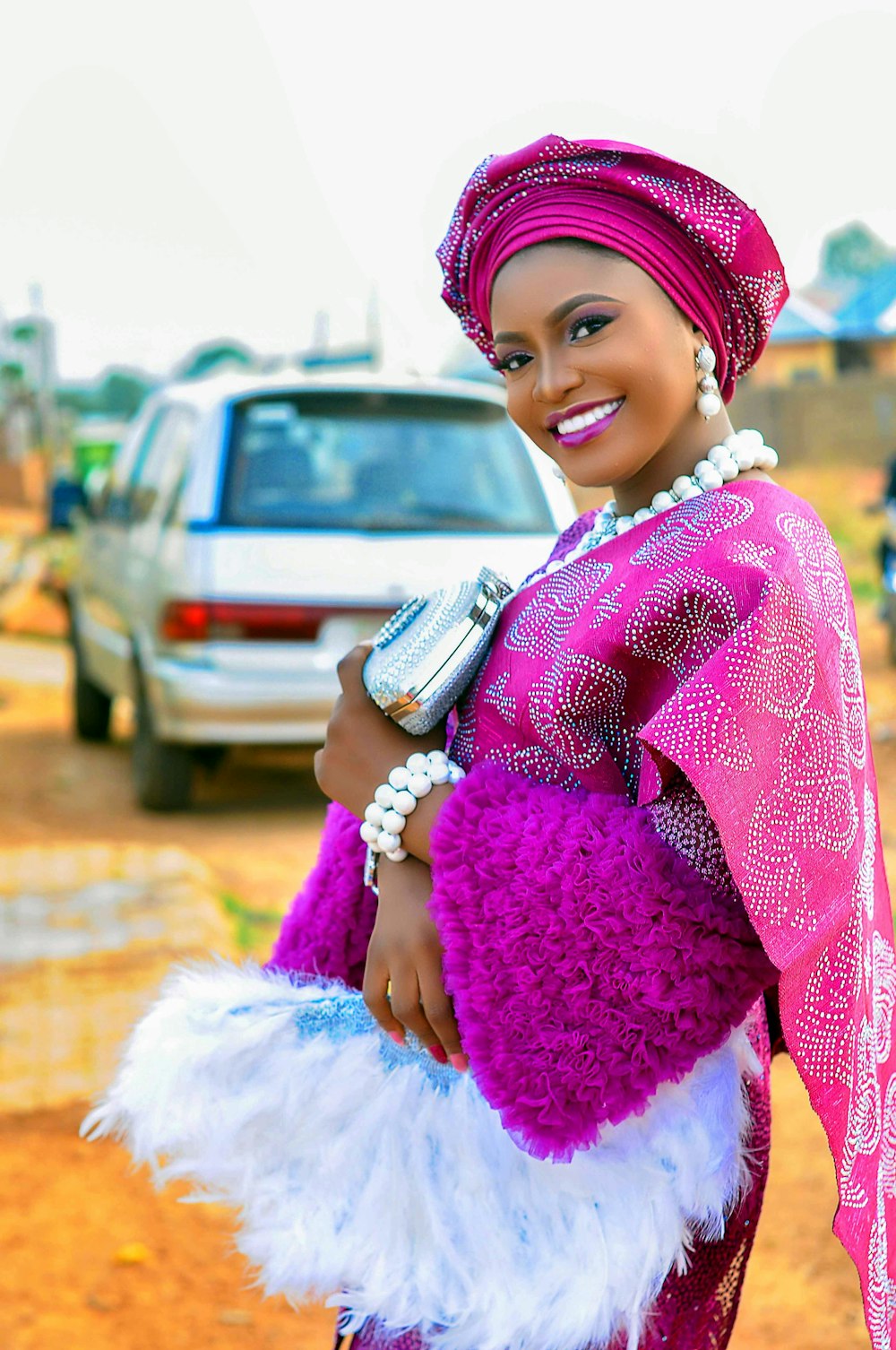 girl in pink and white long sleeve dress holding silver and black phone