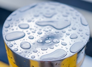 A close-up of a metallic surface coated with a glossy, protective layer.