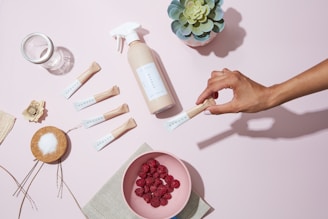 A minimalist flat lay of orijin’s ube powder packaging lying amidst purple-hued fabrics and kitchen utensils.