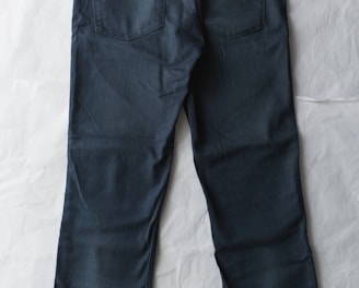 blue denim jeans on white textile
