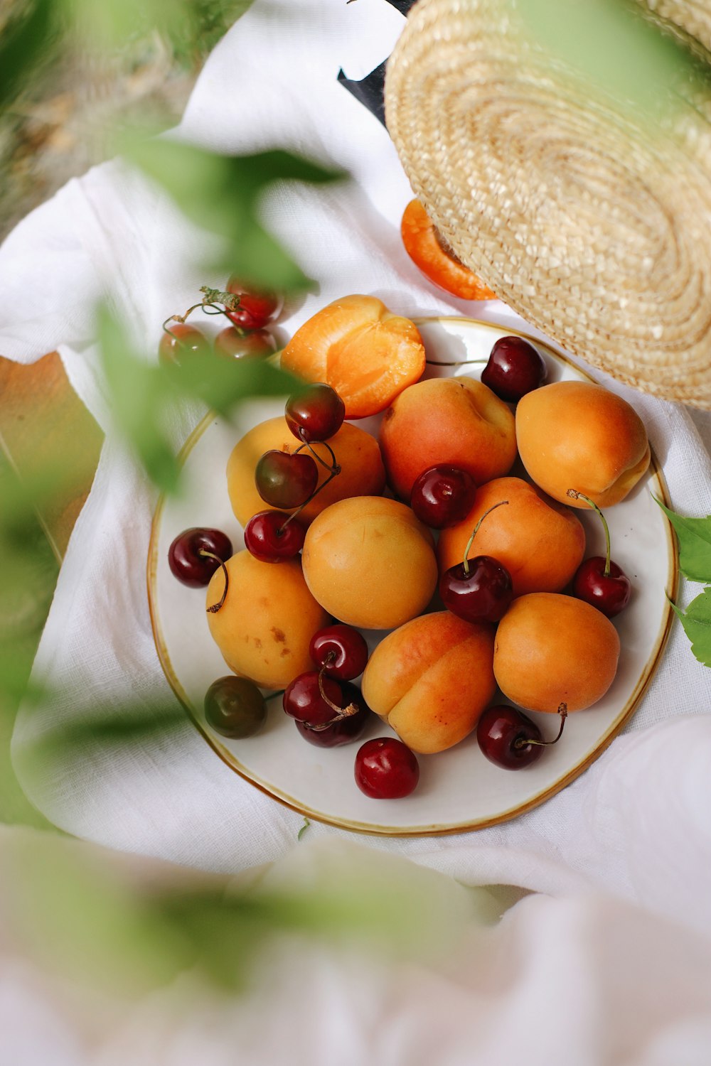 red and yellow fruit on white ceramic plate