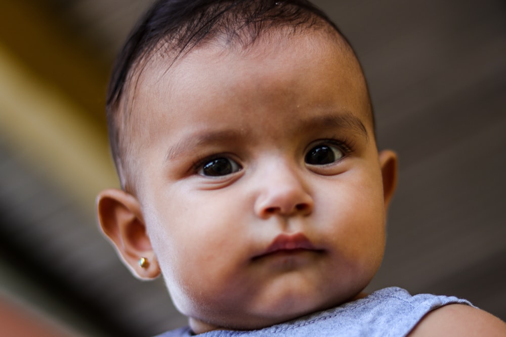 boy in gray shirt looking at the camera